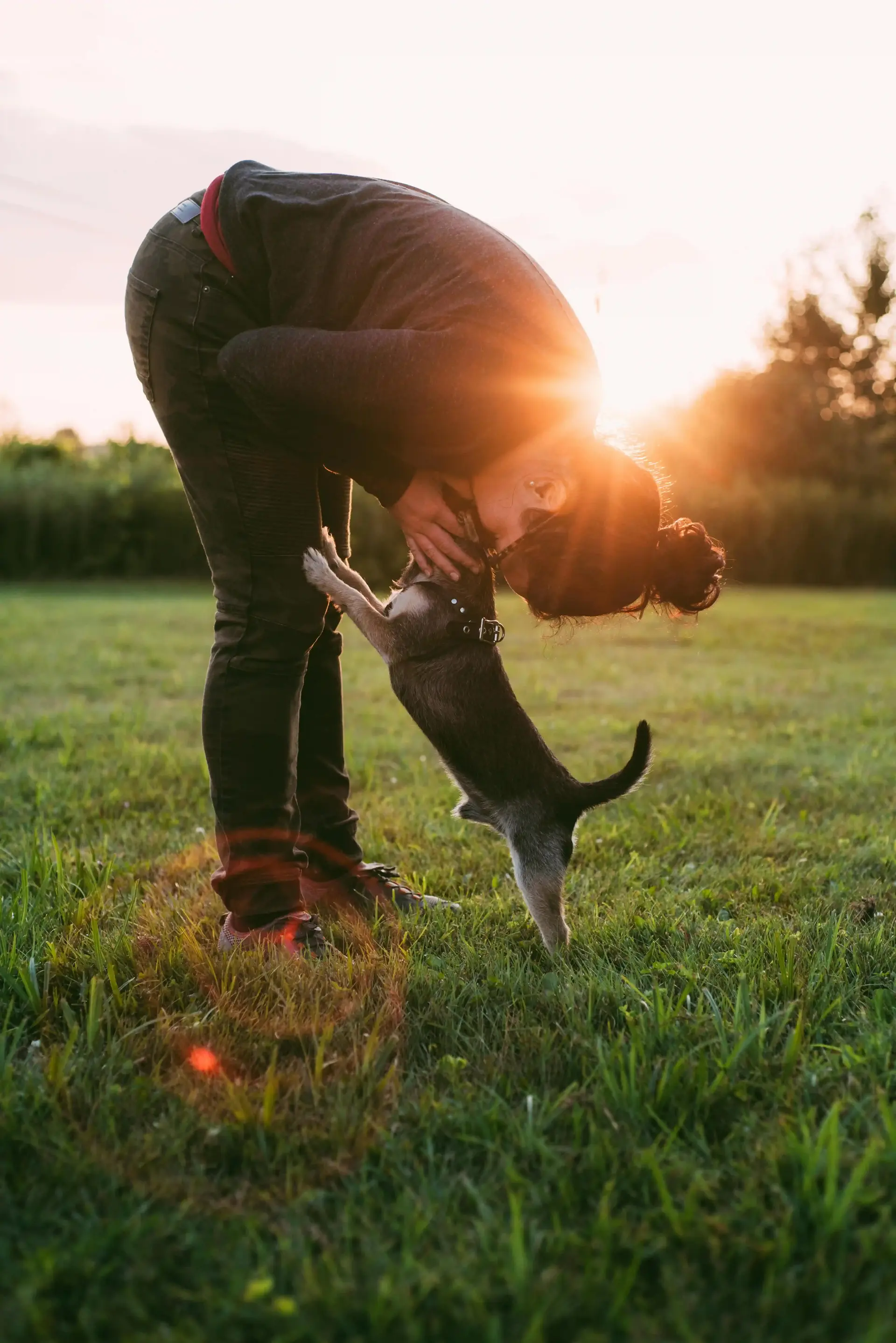 Girl leaning over to kiss her dog, showing new happiness on her mental health medications