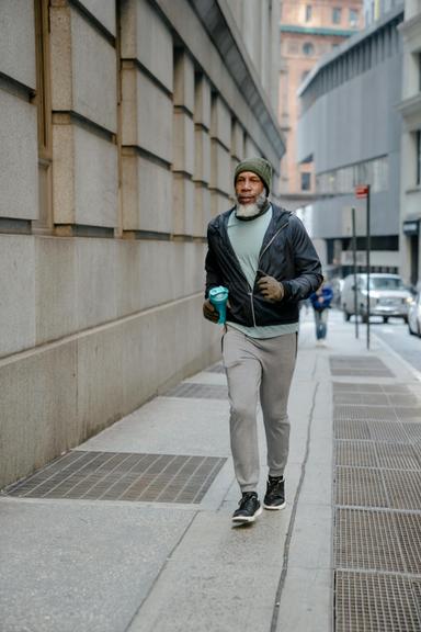 A man jogging in the city as part of his health coaching and functional therapy in Wake Forest